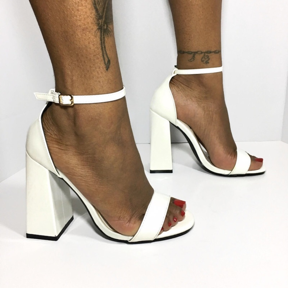 Women’s all white single strap heels.